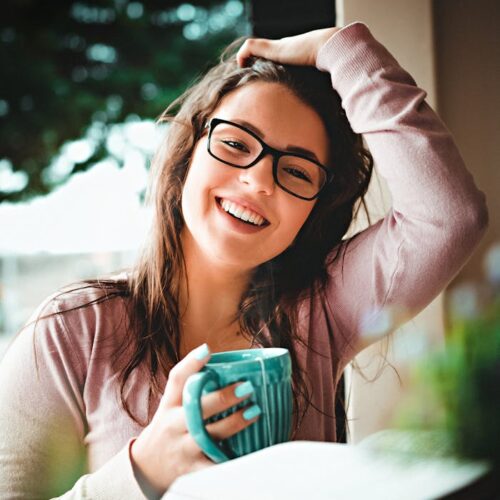 Woman With Black Framed Eyeglasses Holding Green Ceramic Mug