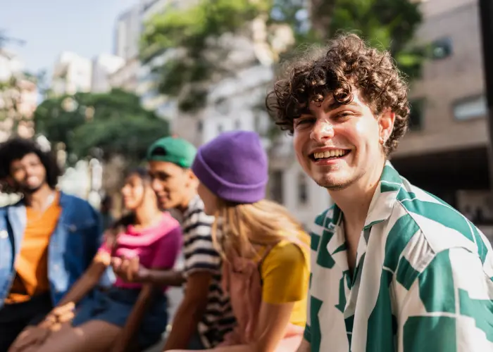 Woman Smiling In Front Of Green Plants
