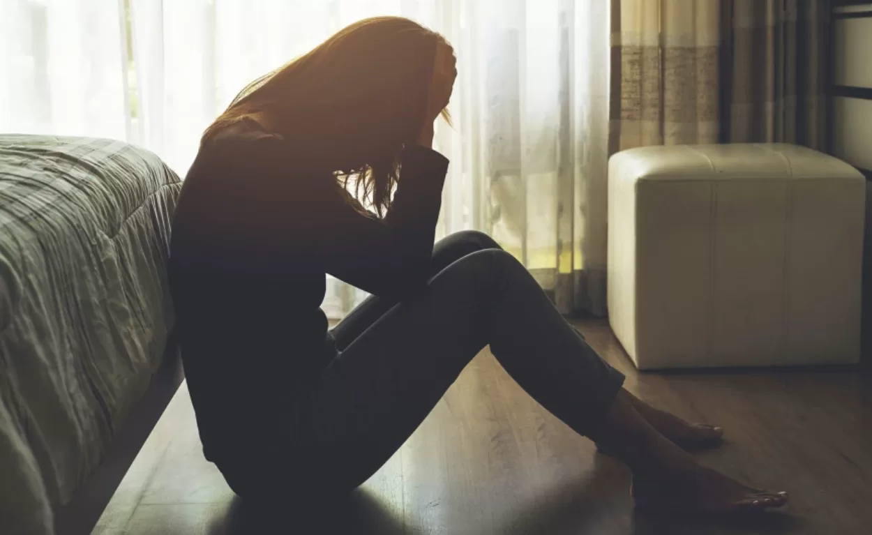 a man walking a dog down a dirt road